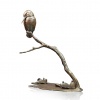 Bronze sculpture of a kingfisher on a branch above some waterlilies