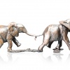 Bronze sculpture of two elephants following each other