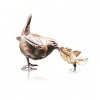 Bronze sculpture of a wren with a golden feather in its beak