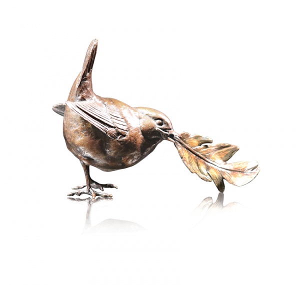 Bronze sculpture of a wren with a golden feather in its beak