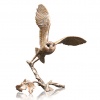 Bronze sculpture of a barn owl in flight