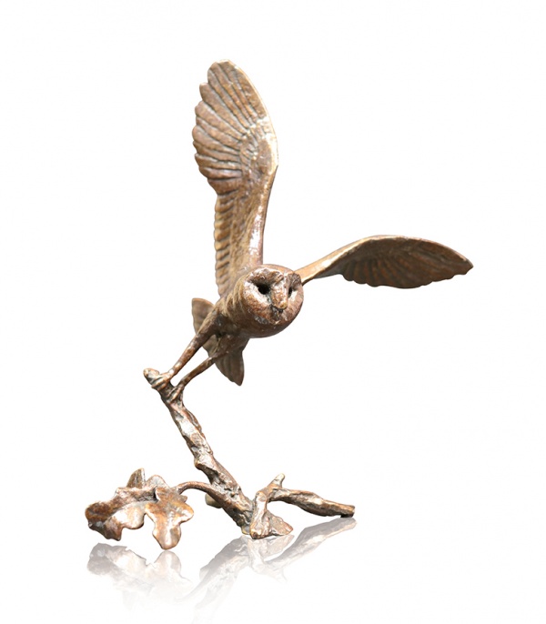 Bronze sculpture of a barn owl in flight
