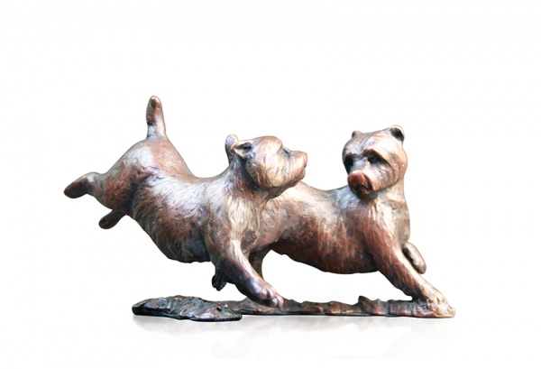 Bronze sculpture of two westie dogs playing together