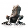 small bronze frog looking up alert
