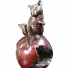 bronze sculpture of a small mouse on an apple
