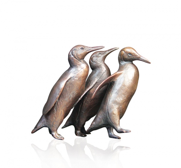 bronze sculpture of a group of penguins walking