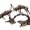 large bronze sculpture of two stags rutting at dawn