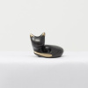 bronze sculpture of a cat curled up by yenny cocq