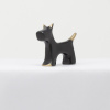 bronze sculpture of a dog in a black patina with polished features by artist yenny cocq