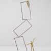 signed limited edition bronze sculpture by artist Anna Andreadi of geometric balancing shapes with two characters
