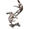 bronze sculpture of two hares boxing