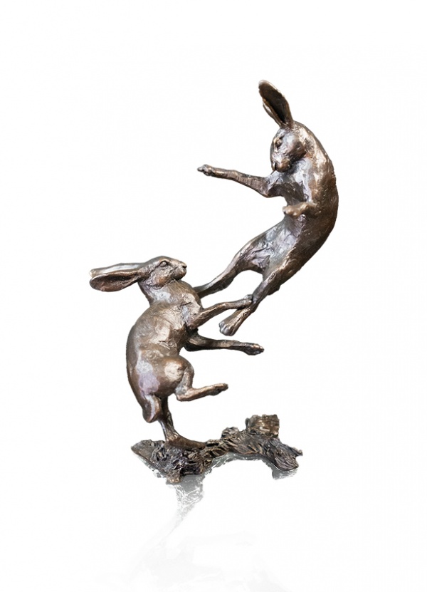bronze sculpture of two hares boxing
