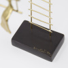 Limited Edition hand made bronze sculpture featuring a woman swinging after having climbed a large ladder by Anna Andreadi