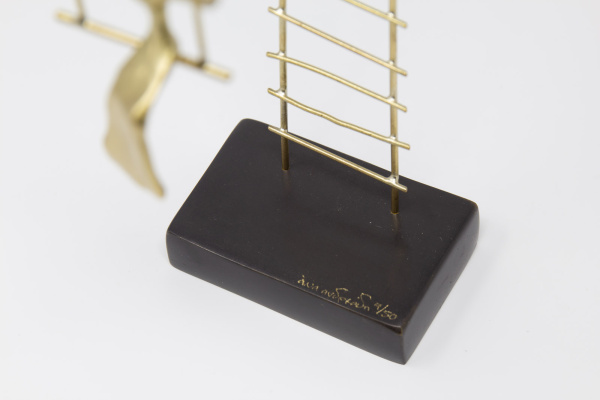Limited Edition hand made bronze sculpture featuring a woman swinging after having climbed a large ladder by Anna Andreadi