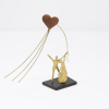 Limited Edition Bronze Sculpture featuring a couple in a romantic setting with a heart shaped kite by Anna Andreadi
