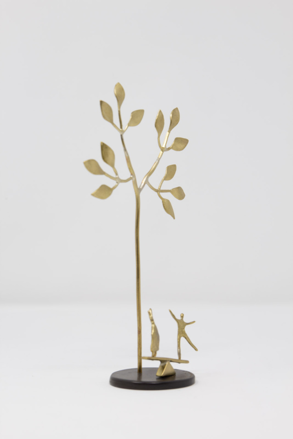 Limited Edition hand made bronze sculpture featuring a couple celebrating under a tree on top of a seesaw by Anna Andreadi