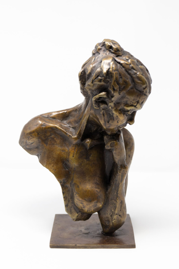 solid bronze sculpture of an upper female torso with breast exposed and a pensive look with fist under chin by Cat Vitebsky
