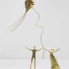 Limited Edition hand made bronze sculpture featuring a couple with their hands up at the same time as holding a kite celebrating by Anna Andreadi