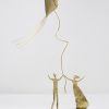 Limited Edition hand made bronze sculpture featuring a couple with their hands up at the same time as holding a kite celebrating by Anna Andreadi