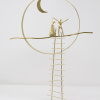 Limited Edition hand made bronze sculpture featuring a couple with the man holding the hand of the woman dancing celebrating under the moon light by Anna Andreadi