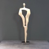 a minimalist bronze sculpture of a figure standing