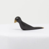 bronze sculpture of a bird in a black patina with polished features by artist yenny cocq