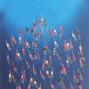 resin painting with ocean blue and swimmers created with textiles on the surface by Ruben Abstract