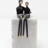 romantic sculpture of bronze figures embracing on a stone marble base by Yenny Cocq