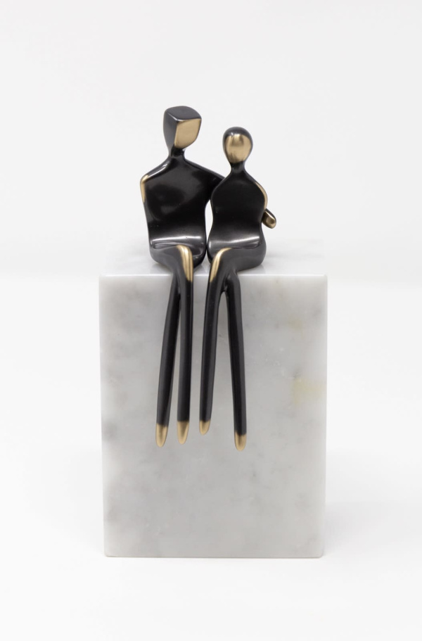 romantic sculpture of bronze figures embracing on a stone marble base by Yenny Cocq