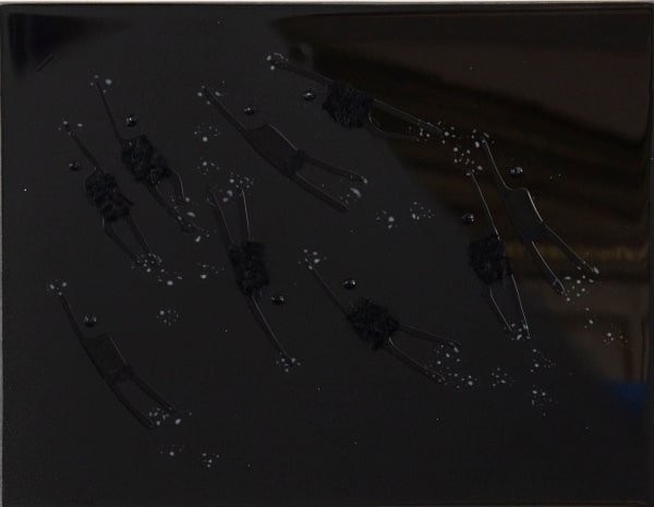 monochrome painting in black with resin and swimming figures with textiles applied