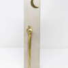 romantic bronze sculpture of two embracing figures set against a textured pillar with a moon above the figures heads by artist anna andreadi