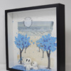 Original sculpture-painting featuring a couple walking in between a blue blossoming trees which are losing their leaves as they pass below by talented and internationally recognised British artist Damilola Odusote